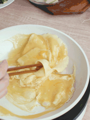 油6成熱時(shí)，下雞蛋液，邊緣凝固時(shí)翻拌成塊狀。